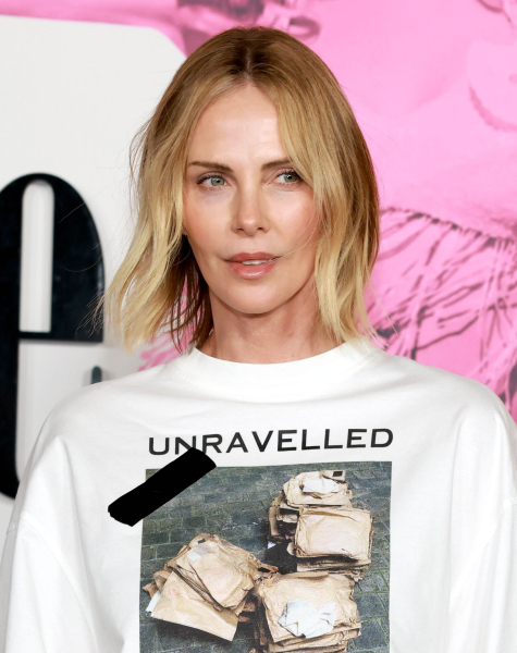 Charlize Theron wearing a white tshirt that says Unravelled